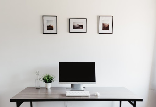 plastic-framed photographs above a desk