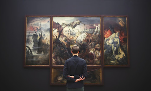 man standing in front of a painting