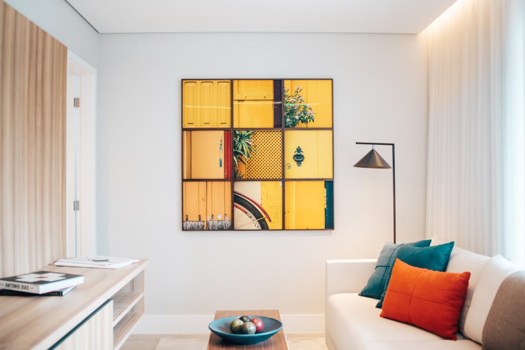 yellow paneled art on a living room wall
